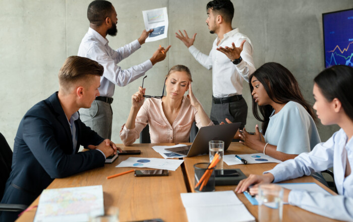 Workplace Conflict. Stressed Group Of Business People Having Disagreements During Corporate Meeting.