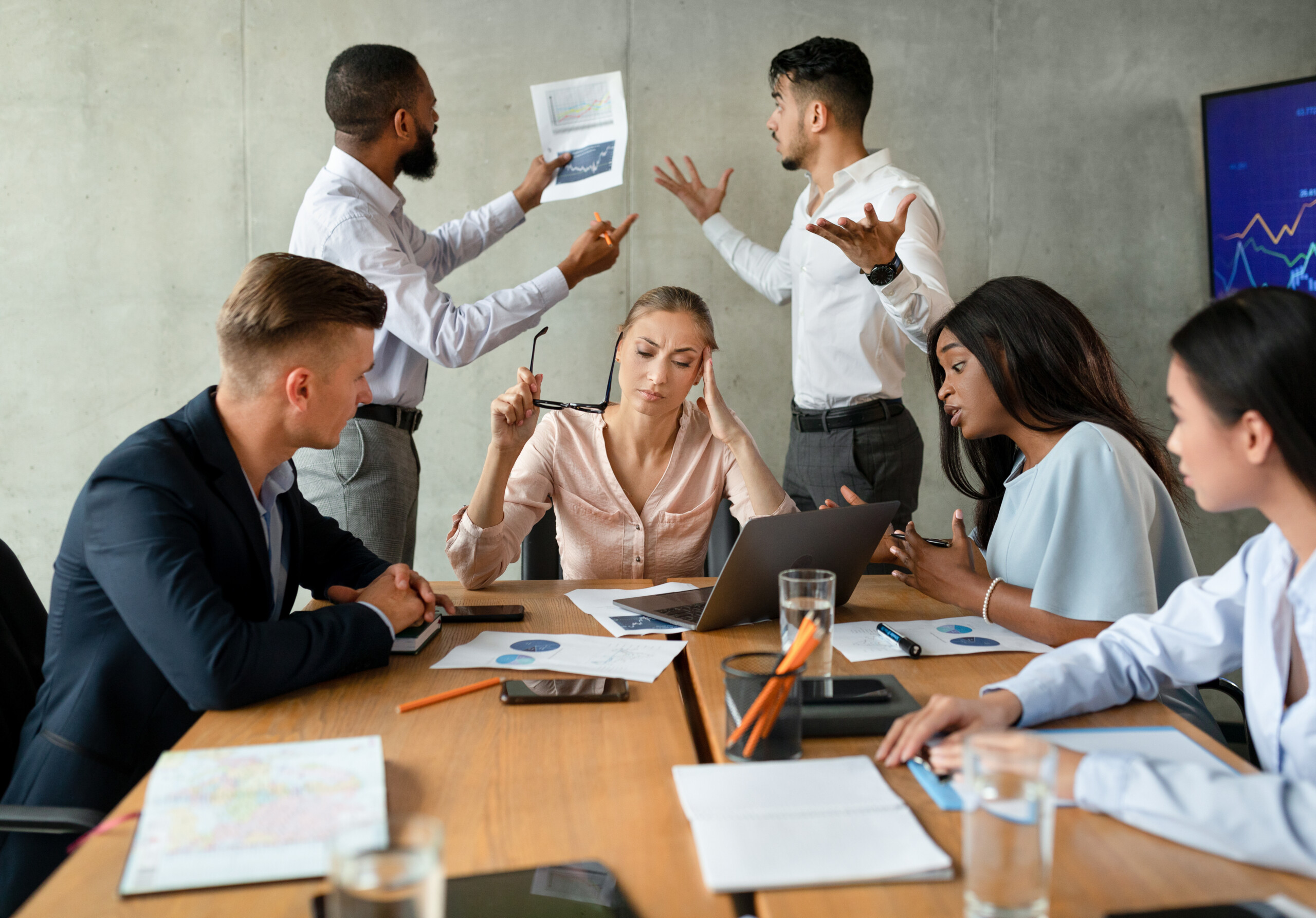 Workplace Conflict. Stressed Group Of Business People Having Disagreements During Corporate Meeting.
